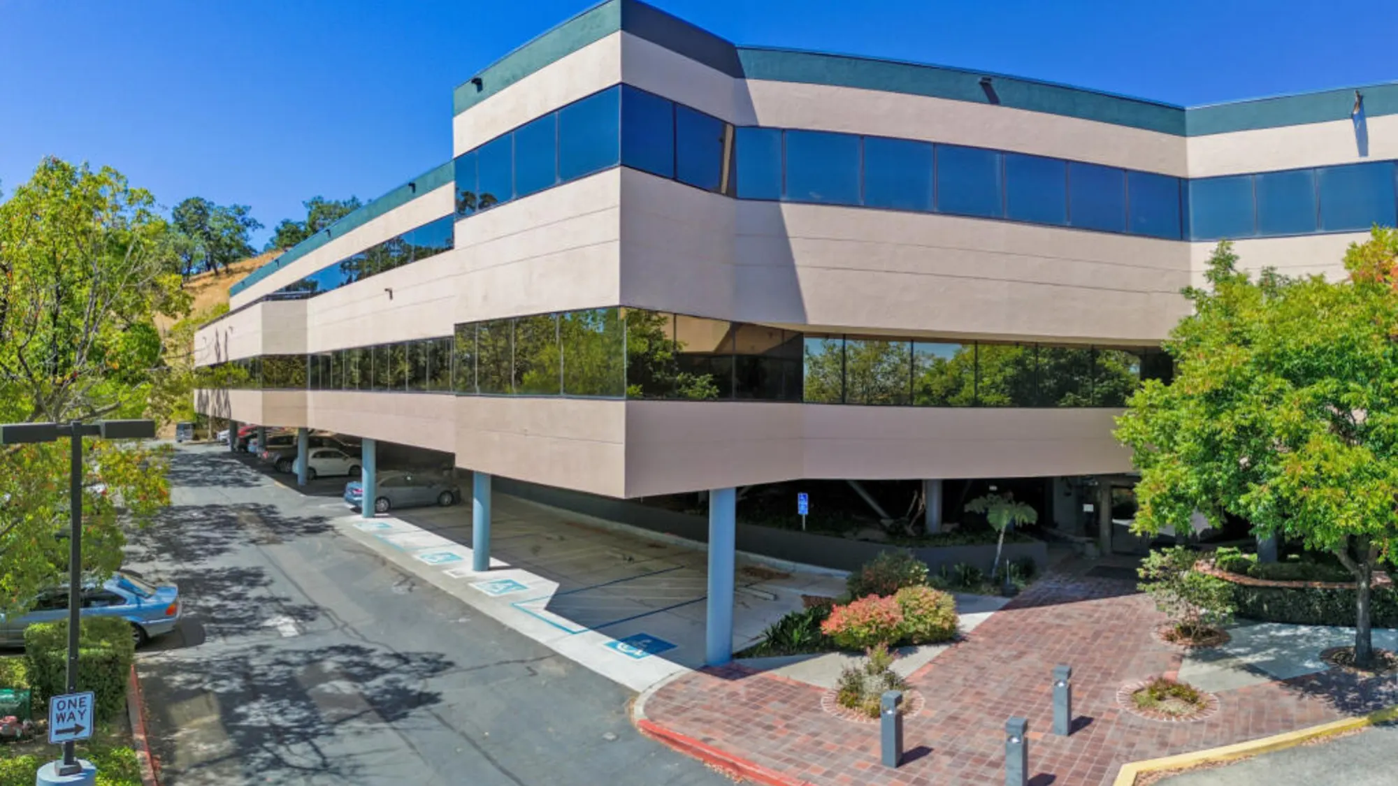 Modern commercial building in Marin County with palm trees and covered parking